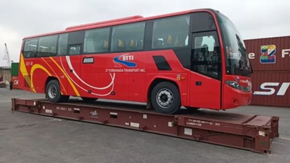 Bus for export is loaded onto the flat rack